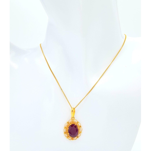 654 - A VERY PRETTY 18K GOLD PENDANT WITH LARGE RUBY ON A 42cms GOLD CHAIN .5.3gms    16522