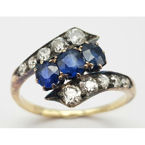 745 - A STUNNING VINTAGE DIAMOND AND SAPPHIRE CROSSOVER STYLE RING ALL STONES BEING TOP QUALITY.   3.2gms ... 