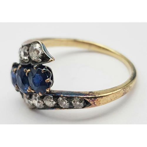 745 - A STUNNING VINTAGE DIAMOND AND SAPPHIRE CROSSOVER STYLE RING ALL STONES BEING TOP QUALITY.   3.2gms ... 