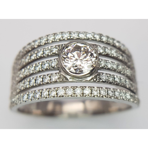 599 - An 18K White Gold Diamond Supreme Half Eternity Ring. O.527ct brilliant round cut central diamond wi... 