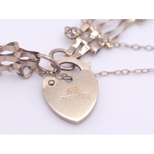 669 - A VERY CUTE MINITURE 9K GOLD GATE BRACELET WITH 
 HEART PADLOCK AND SAFETY CHAIN .  3.8gms    17cms