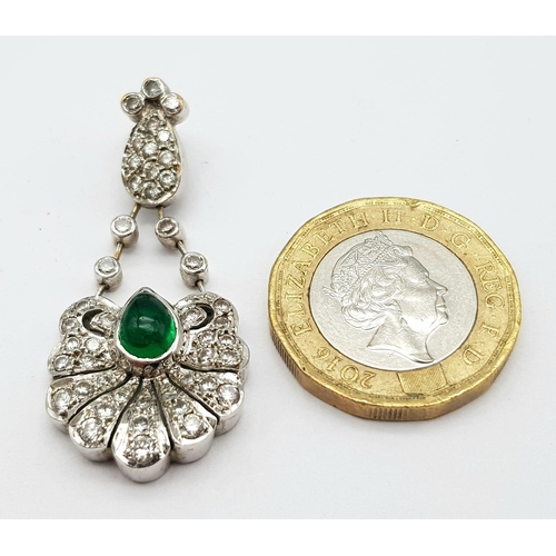 723 - An 18K White Gold Emerald and Diamond Pendant. Central teardrop emerald with a white diamond petal c... 