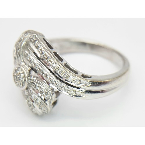 695 - An 18K White Gold Diamond Fancy Crossover Ring. Two  encrusted diamond crossover waves meet at the e... 