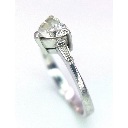 688 - An 18K White Gold and Diamond Solitaire Ring. A near white heart cut VS1 grade central diamond - 0.4... 