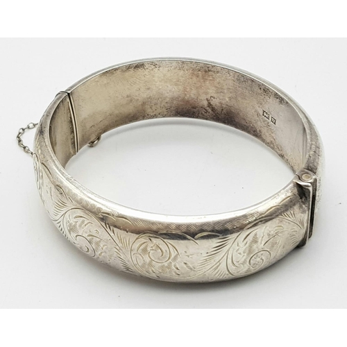 1297 - A Vintage Sterling Silver Bangle. Birmingham hallmarks. Clip open. 6cm inner diameter. 30g weight.