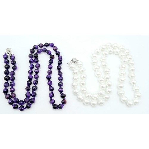 424 - Duo of Beaded Stone Necklaces.
One Pearlescent White (48cm) and one Iridescent Black/Purple Stone (5... 