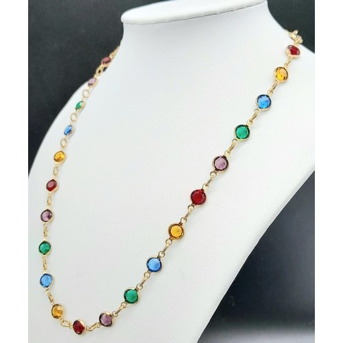 411 - A Gold Filled Jewellery Set.
Featuring a multi-coloured gem necklace (46cm) and matching drop earrin... 