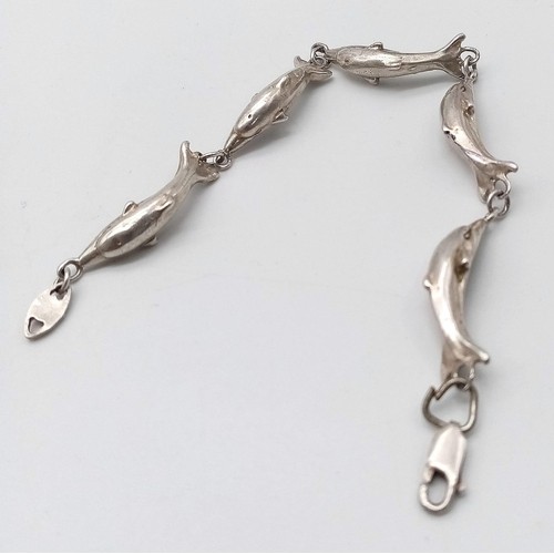 418 - A Sterling Silver Dolphin bracelet. 
6cm in diameter. 
Weight: 12.66g