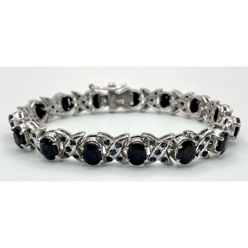 146 - An Oval Cut Blue Sapphire Tennis Bracelet set in 925 Sterling Silver. 33ctw. W-25g. 18cm length.