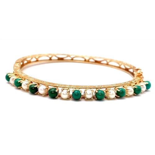 139 - A 14K GOLD HINGED BANGLE DECORATED WITH JADE AND SEED PEARLS WITH OPEN WORK BACK HALF AND NICELY HAN... 