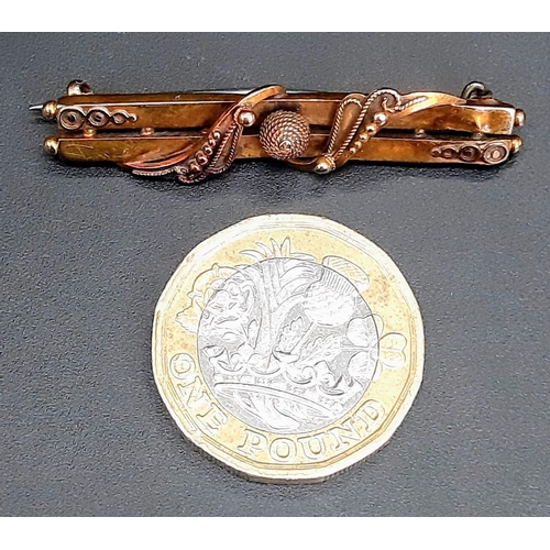 17 - An Antique 15K Rose Gold Bar Brooch. Ornate decoration. Pin has been replaced. 4.5cm length. 3g weig... 