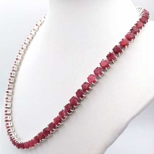 296 - A Ruby Gemstone Tennis Necklace set in 925 Silver. Round cut rubies. 45cm length. 49g total weight. ... 