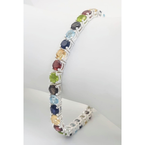 303 - A Garnet, Citrine, Blue Topaz, Peridot Bracelet set in 925 Silver. 19cm length. 16.7g total weight. ... 