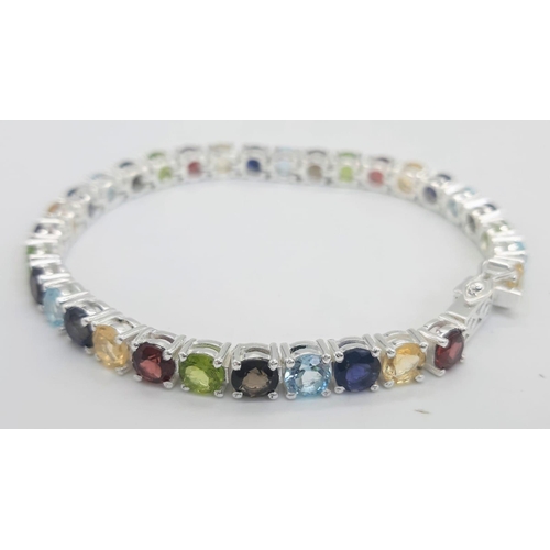 303 - A Garnet, Citrine, Blue Topaz, Peridot Bracelet set in 925 Silver. 19cm length. 16.7g total weight. ... 