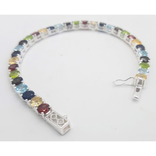 303 - A Garnet, Citrine, Blue Topaz, Peridot Bracelet set in 925 Silver. 19cm length. 16.7g total weight. ... 