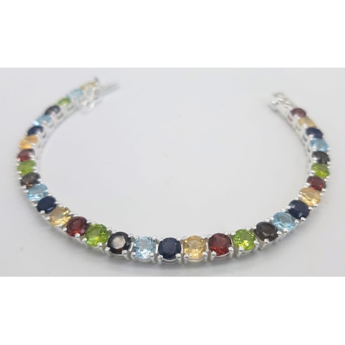 303 - A Garnet, Citrine, Blue Topaz, Peridot Bracelet set in 925 Silver. 19cm length. 16.7g total weight. ... 