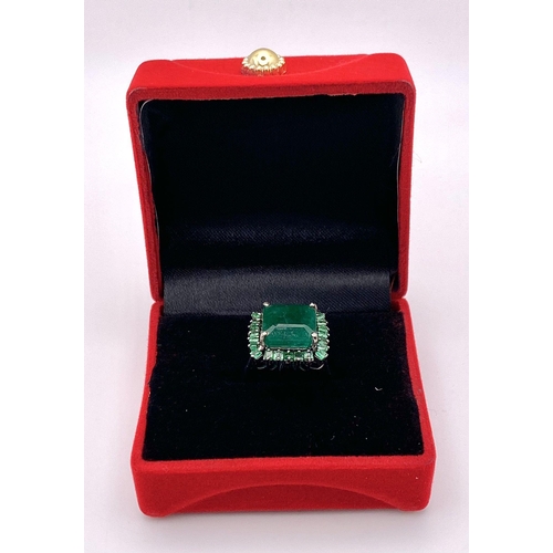 352 - A 7.80ct Emerald Ring with 0.90ctw of Emerald Accents. Set in 925 Silver. Size M. 6.46g total weight... 