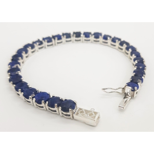 400 - A Blue Sapphire Gemstone Tennis Bracelet set in 925 Silver.
18cm length. 19.75g total weight. Ref: C... 