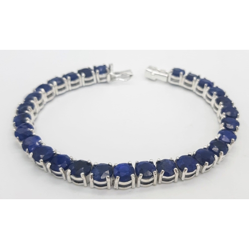 400 - A Blue Sapphire Gemstone Tennis Bracelet set in 925 Silver.
18cm length. 19.75g total weight. Ref: C... 