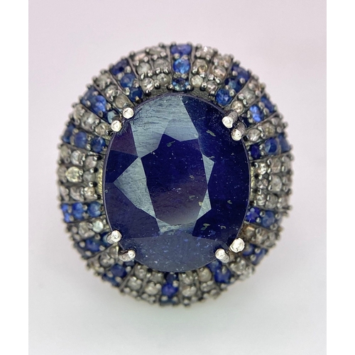 436 - A 13ct Blue Oval Cut Sapphire Ring with 0.90ctw Blue Sapphires and 0.90ctw Diamond accents. Set in 9... 