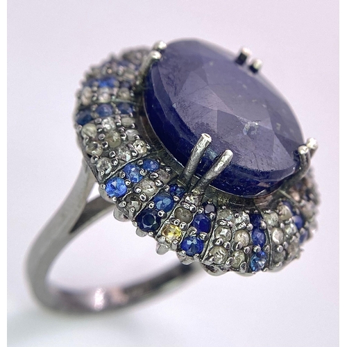 436 - A 13ct Blue Oval Cut Sapphire Ring with 0.90ctw Blue Sapphires and 0.90ctw Diamond accents. Set in 9... 