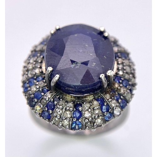 436 - A 13ct Blue Oval Cut Sapphire Ring with 0.90ctw Blue Sapphires and 0.90ctw Diamond accents. Set in 9... 