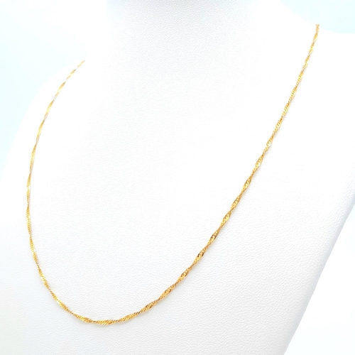 464 - An Italian 9K Yellow Gold Twisted Flat Curb Necklace. 60cm length. 2.31g weight.