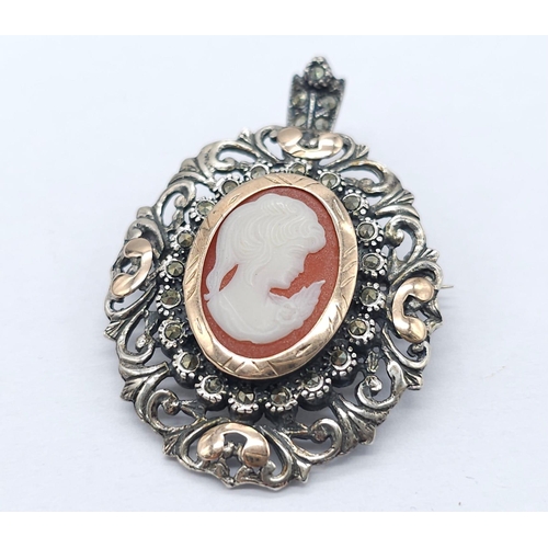 374 - An Antique Silver and Rose Gold Decorative Cameo Brooch. 
Central small cameo with a rose gold halo ... 