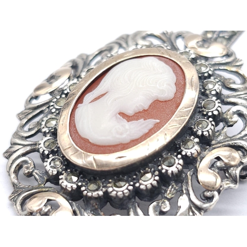 374 - An Antique Silver and Rose Gold Decorative Cameo Brooch. 
Central small cameo with a rose gold halo ... 