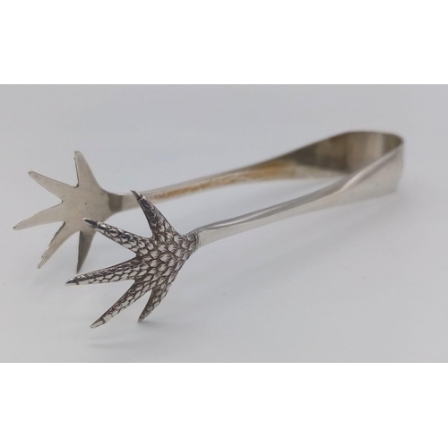 465 - An antique sterling silver Eagle claw sugar tongs. Full hallmarks Birmingham, 1937. Total weight 26.... 