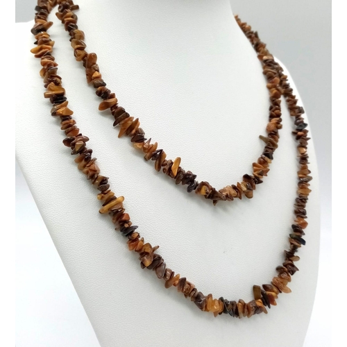 111 - A parcel of Two Vintage Long Natural Stone Necklaces.
Both measure 90cm in length. The white necklac... 