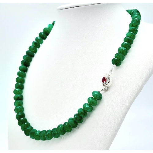 227 - A 310ctw Emerald Necklace with Ruby and Diamond Clasp, set in 925 Silver. 42cm length. 63g total wei... 