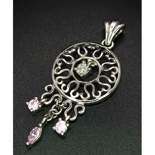 360 - A 9K white gold diamond and pink sapphire circular articulated pendant, 2.7g, 4cm length (dia:0.10ct... 