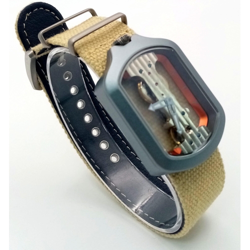 51 - A Verticale Mechanical Top Winder Unisex Watch. Beige textile strap with silver tone skeleton case. ... 