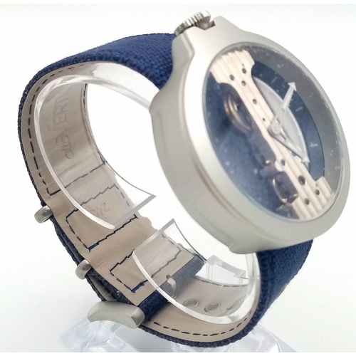 92 - A Verticale Mechanical Top Winder Unisex Watch. Navy blue strap, silver toned skeleton case. As new ... 