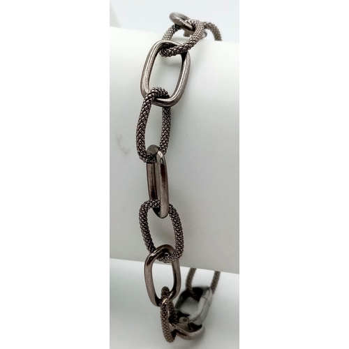 109 - A 925 Silver Elongated Link Bracelet with a Black Rhodium Coating. Weight - 13.50g. 18cm length. Com... 