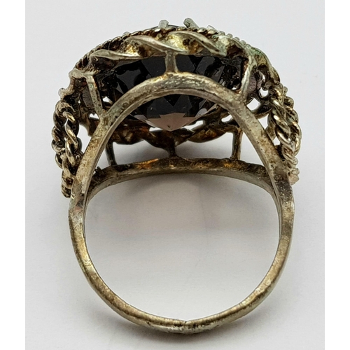 71 - A vintage large smoky quartz faceted stone set ring on crown mount, with lovely scroll work on shoul... 