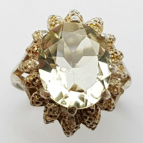 79 - A vintage large faceted citrine stone set silver ring floral design, weight 4.2g and size L