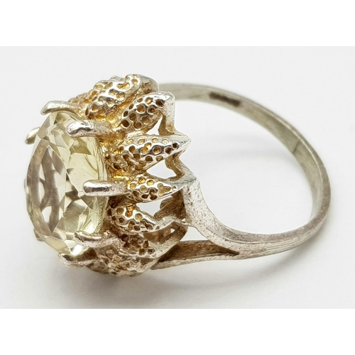 79 - A vintage large faceted citrine stone set silver ring floral design, weight 4.2g and size L