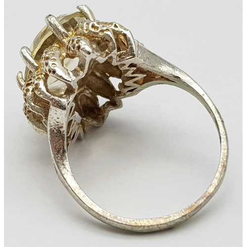 79 - A vintage large faceted citrine stone set silver ring floral design, weight 4.2g and size L