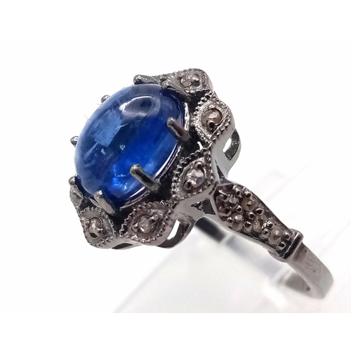 86 - A Kyanite Cabochon Diamond Ring set in 925 Silver with a Black Rhodium Coating. Weight - 3.50g. Kyan... 