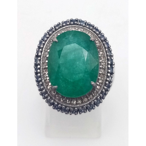 366 - An 8ct Emerald Ring with 0.80ctw of Blue Sapphire and 0.65ct Diamond Accents. Set in 925 Silver. Siz... 