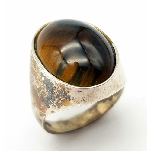 65 - A vintage large tiger's eye stone set silver ring, size N weight 6.7g