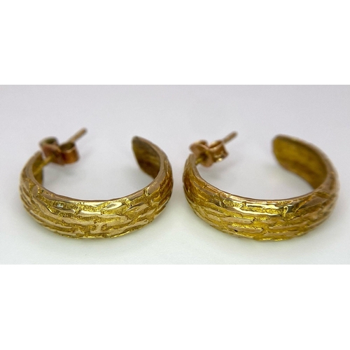 1111 - A Pair of Vintage 9K Yellow Gold Textured Hoop Earrings. 
2.57g total weight.