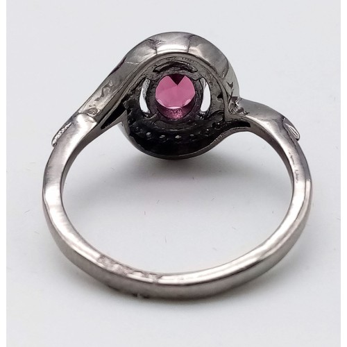 38 - A Garnet and Diamond Ring set  in 925 Silver with a Black Rhodium coating. Oval cut Garnet- 0.80ct. ... 