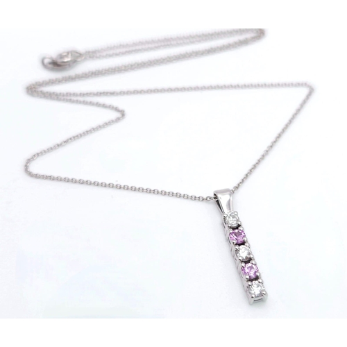 1266 - An 18 K white gold drop pendant with diamonds and pink sapphires (rubies) on an 18 K white gold chai... 