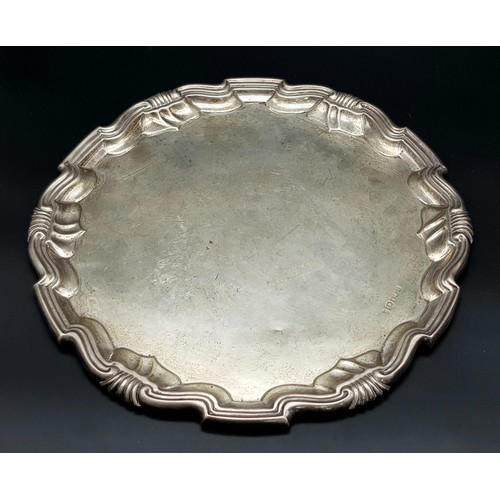 1301 - An Antique Sterling Silver Salver with a Decorative scrolled edge. 31cm diameter. 606g weight. Londo... 