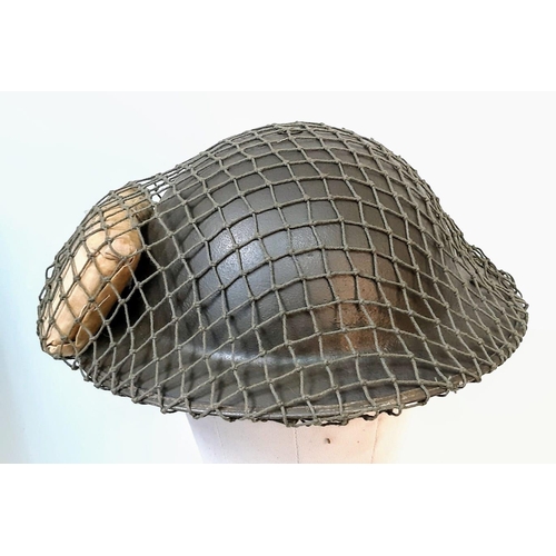 167 - WW2 British MK II Helmet with Cam Net and 1944 Dated (D-Day) Field Dressing.