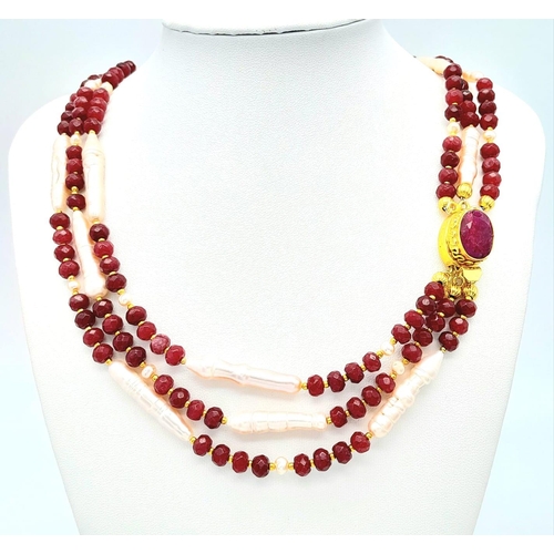 228 - A very glamorous three row necklace and bracelet set with multi-faceted rubies and large, pink, unus... 