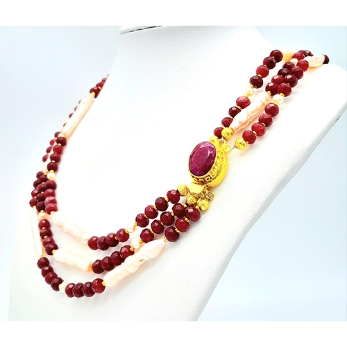 228 - A very glamorous three row necklace and bracelet set with multi-faceted rubies and large, pink, unus... 